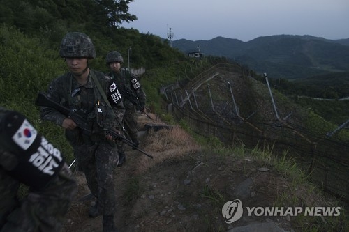 In this undated file photo, South Korean soldiers patrol the border with North Korea. (Yonhap)