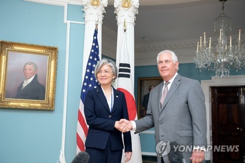 This file photo provided by the Ministry of Foreign Affairs shows South Korean Foreign Minister Kang Kyung-wha (L) shaking hands with U.S. Secretary of State Rex Tillerson prior to their talks in Washington on June 29, 2017. (Yonhap)