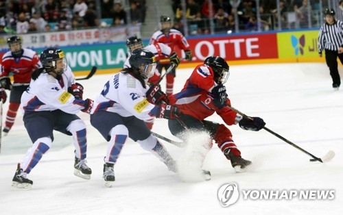 In this file photo taken on April 6, 2017, South Korean and North Korean women's hockey players -- in white and red, respectively -- are in action during the International Ice Hockey Federation World Championship Division II Group A tournament at Gangneung Hockey Centre in Gangneung, Gangwon Province. (Yonhap)