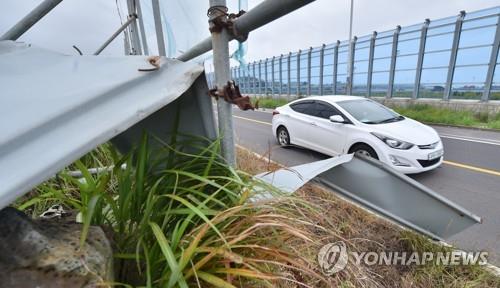 A construction site fence destroyed by strong winds is seen on a road on Jeju Island on June 30, 2020. (Yonhap)