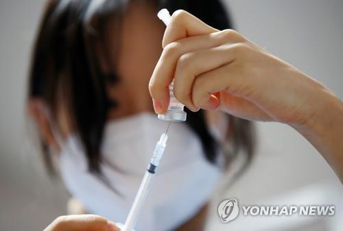 This March 2, 2021, photo shows a medical worker preparing to give a shot of AstraZeneca's COVID-19 vaccine at a nursing home in Seoul. (Yonhap)
