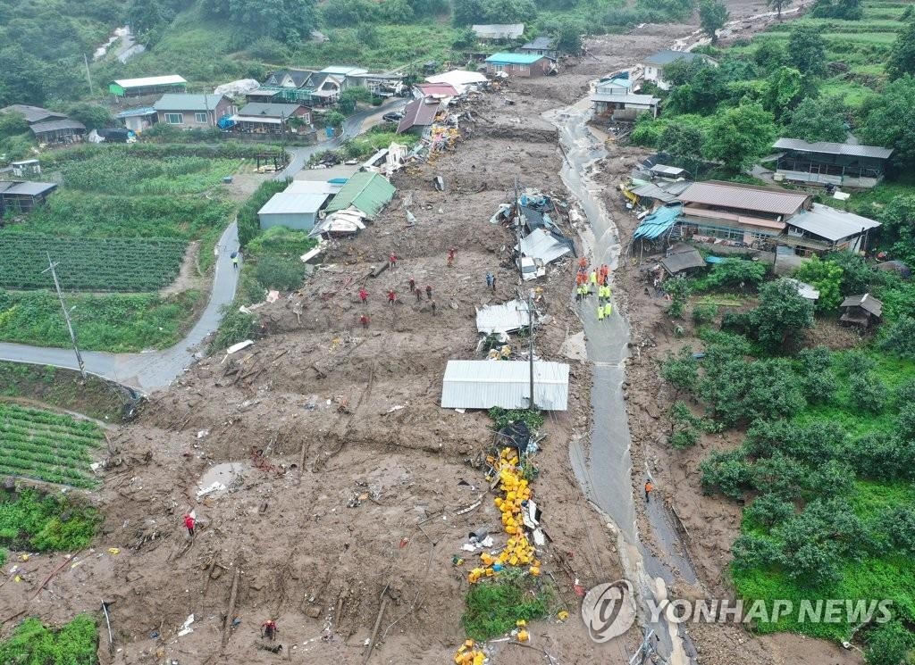 Firefighters conduct rescue operations in a village hit by a landslide in the southeastern county of Yecheon on July 15, 2023.