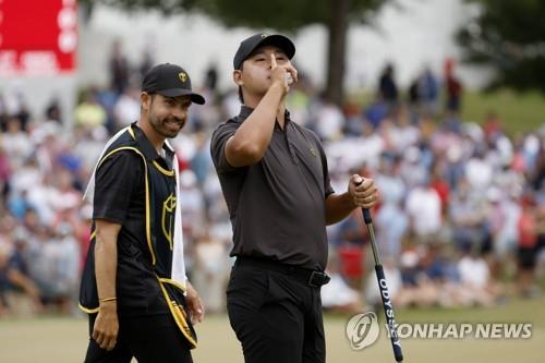 In this Getty Images file photo from Sept. 25, 2022, Kim Si-woo of South Korea, playing for the International Team team, shushes the crowd after making a putt on the 15th green during his singles match against Justin Thomas of the United States during the Presidents Cup at Quail Hollow Country Club in Charlotte, North Carolina. (Yonhap)