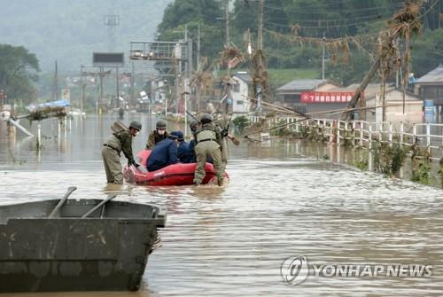지난해 7월 일본 구마모토현 폭우 현장에서 고무보트를 이용해 인명구조 활동을 하는 자위대원. [EPA=연합뉴스 자료사진] 