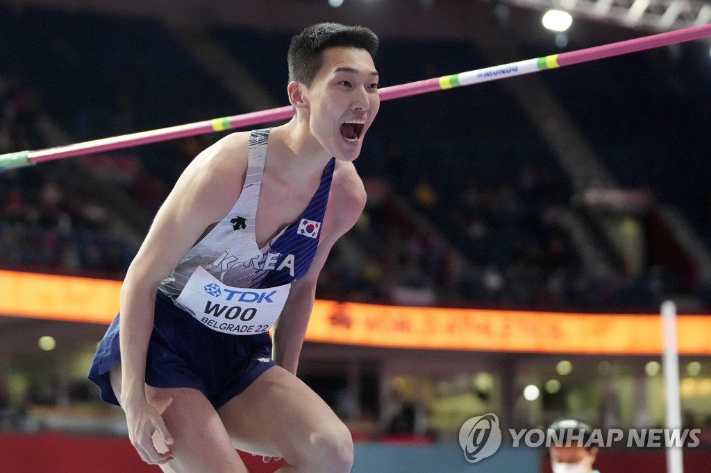 In this Associated Press photo, Woo Sang-hyeok of South Korea celebrates after a successful attempt in the men's high jump at the World Athletics Indoor Championships at Stark Arena in Belgrade on March 20, 2022. (Yonhap)