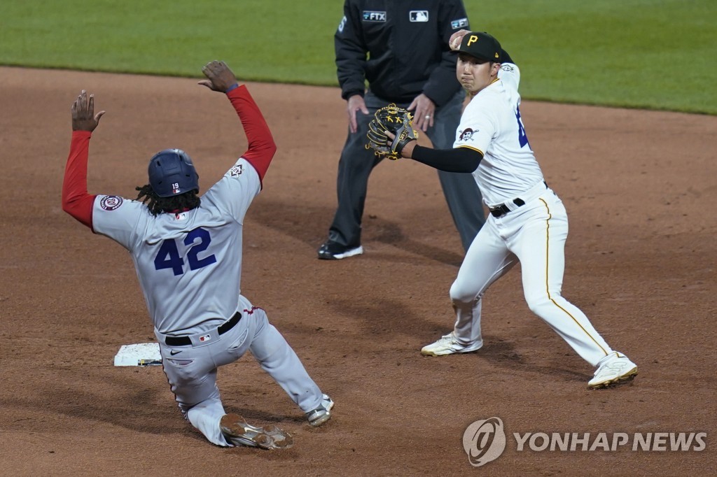 In this Associated Press file photo from April 15, 2022, Pittsburgh Pirates' shortstop Park Hoy-jun (R) throws to first to complete a double play against the Washington Nationals during the top of the sixth inning of a Major League Baseball regular season game at PNC Park in Pittsburgh. (Yonhap)