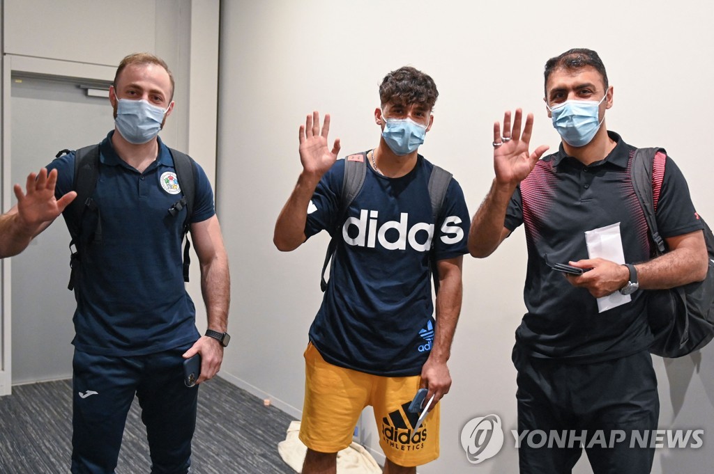 도쿄에 도착한 난민팀 선수 2명과 코치