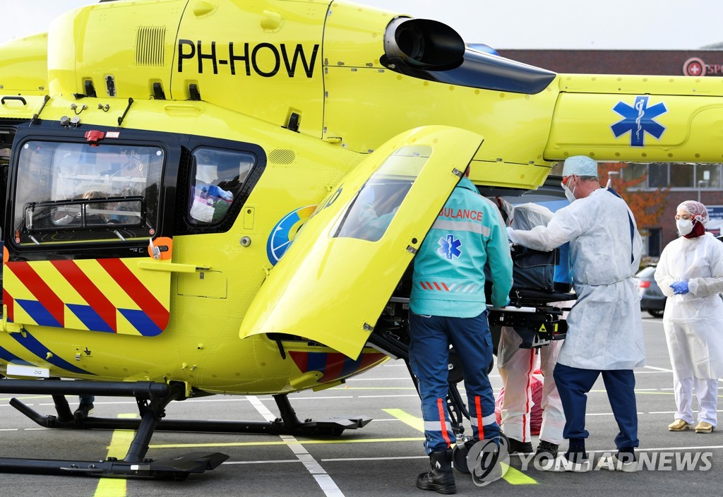 지난 23일(현지시간) 네덜란드에서 신종 코로나바이러스 감염증(코로나19) 환자 한 명을 독일 병원으로 이송하기 위해 헬리콥터에 태우고 있다. [로이터=연합뉴스 자료사진]
