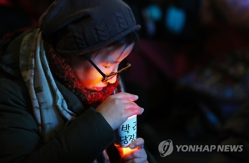 촛불에 손 녹이는 시민