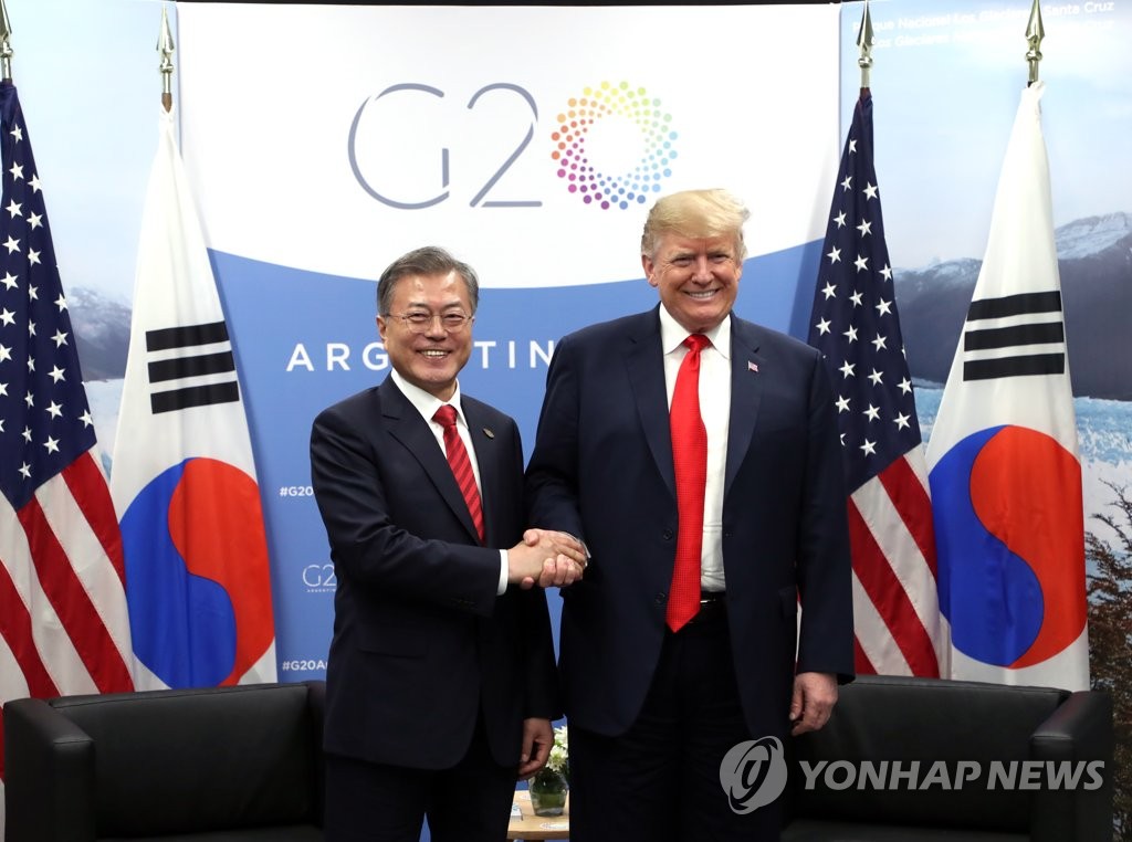 In the photo taken Dec. 1, 2018, South Korean President Moon Jae-in and U.S. President Donald Trump shake hands before holding a bilateral summit on the sidelines of the Group of 20 summit in Buenos Aires. (Yonhap)