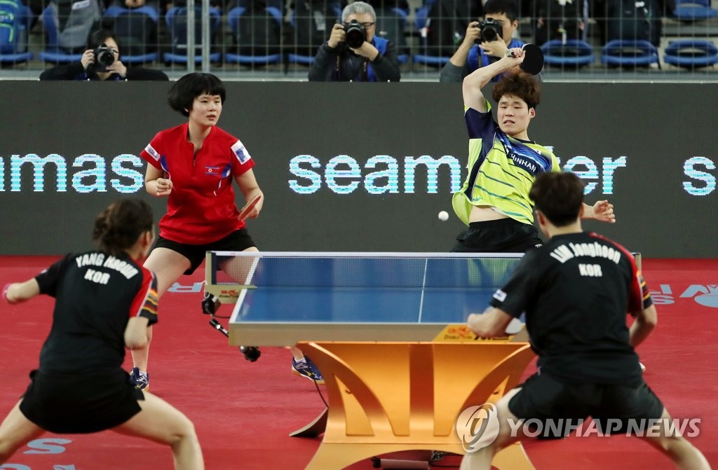 Cha Hyo-sim of North Korea (top left) and Jang Woo-jin of South Korea (top right) compete against Yang Ha-eun (bottom left) and Lim Jong-hoon (bottom right) of South Korea in the mixed doubles semifinals at the International Table Tennis Federation World Tour Grand Finals on Dec. 14, 2018, at Namdong Gymnasium in Incheon, 40 kilometers west of Seoul. (Yonhap)