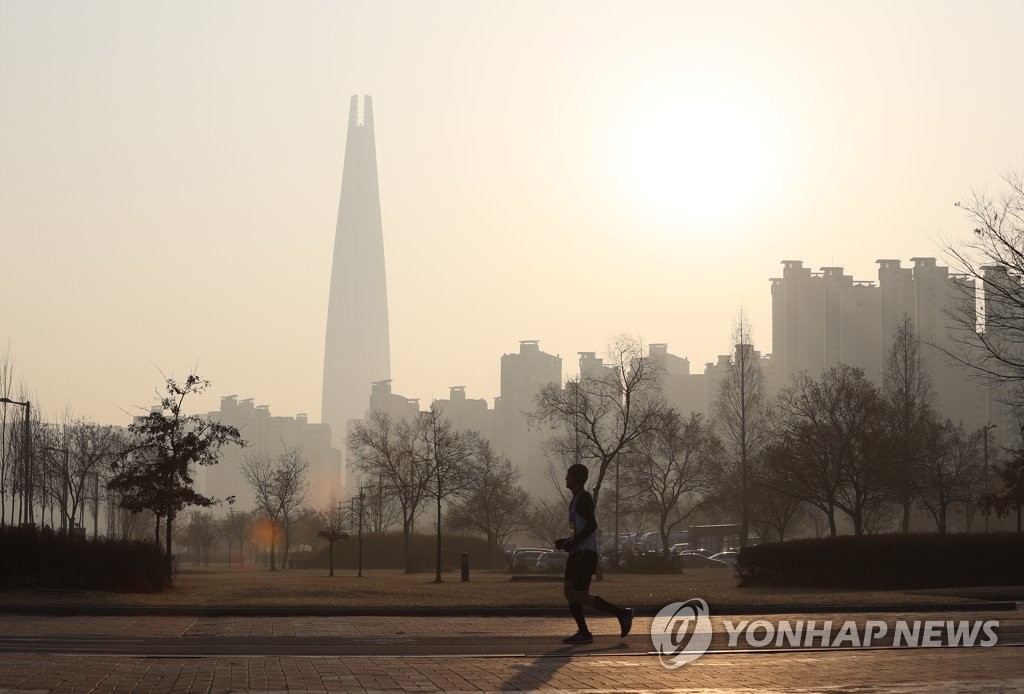 This photo, taken on Feb. 15, 2020, shows a man running in a park in southeastern Seoul, as the city is hit by fine dust air pollution. (Yonhap)