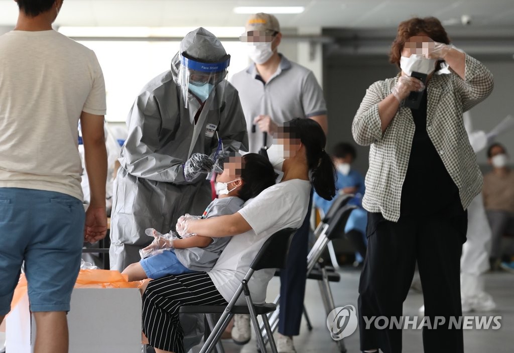 Seoul citizens go through new coronavirus tests at a temporary testing site established at Wangsung Church in the southeastern area of the capital on June 26, 2020. (Yonhap)
