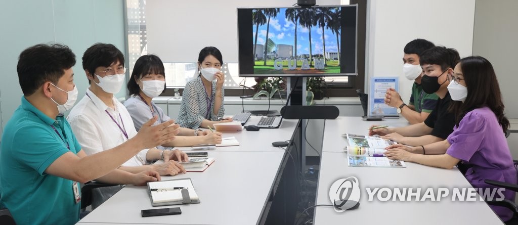 This file photo taken June 2, 2021, shows employees of Hana Tour Service, Inc. headquarters in central Seoul, in a meeting on preparations for group tours to Saipan and other vacation spots starting this summer. (Yonhap)