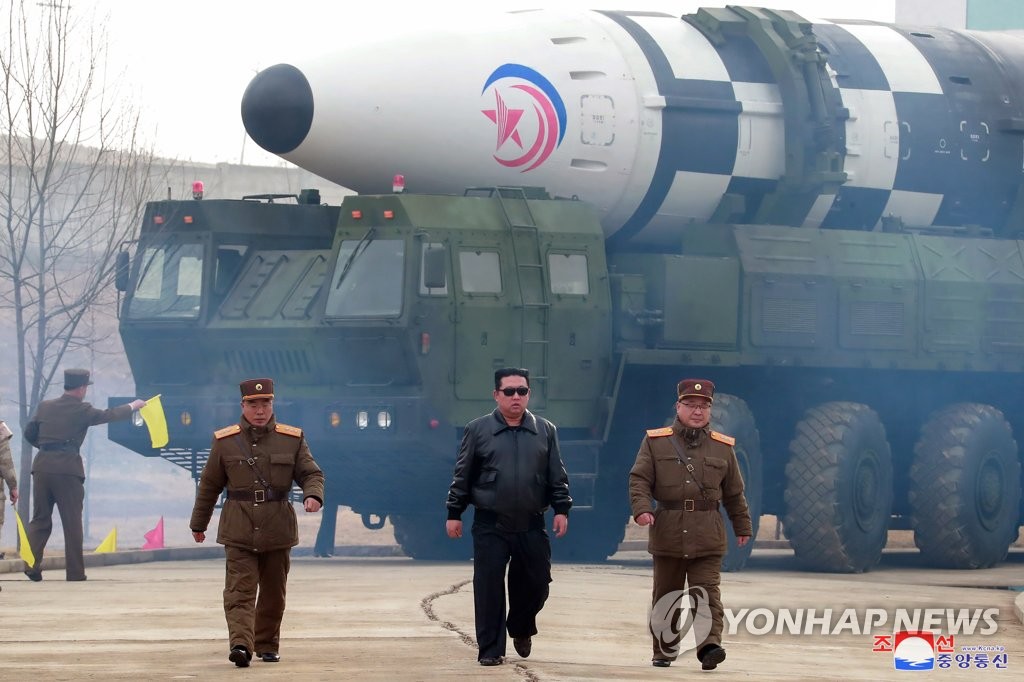 North Korean leader Kim Jong-un (C), accompanied by Jang Chang-ha (L), chief of the North's Academy of National Defense, and Kim Jong-sik, the deputy director of the Munitions Industry Department, visits Pyongyang International Airport on March 24, 2022, to inspect the launch of a Hwasong-17 intercontinental ballistic missile (ICBM), in this photo released by the North's official Korean Central News Agency. The missile traveled up to a maximum altitude of 6,248.5 kilometers and flew a distance of 1,090 km before falling into the East Sea, the KCNA said. (For Use Only in the Republic of Korea. No Redistribution) (Yonhap)