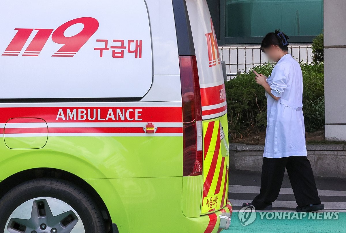 A doctor stands next to an ambulance at a general hospital in Seoul on Aug. 30, 2024. (Yonhap)