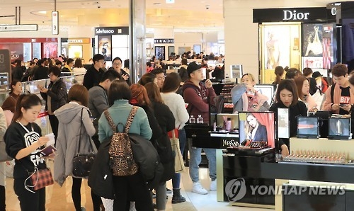 This file photo, taken on Jan. 5, 2017, shows people, including many Chinese tourists, standing in line to purchase goods at a duty-free shop run by Lotte in Seoul. (Yonhap)