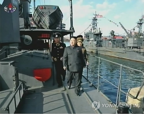 This photo, captured from the North's Central TV on April 6, 2012, shows North Korean leader Kim Jong-un inspecting the captured U.S. spy ship Pueblo. (Yonhap)