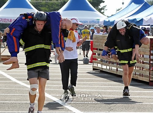 This file photo shows firefighters taking part in the 2010 World Firefighters Games in the South Korean city of Daegu. (Yonhap) 