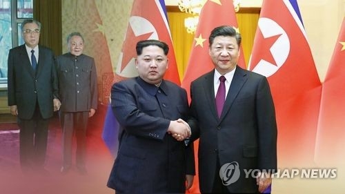 This image, provided by Yonhap News TV, shows Chinese President Xi Jinping (R) and North Korean leader Kim Jong-un. (Yonhap)