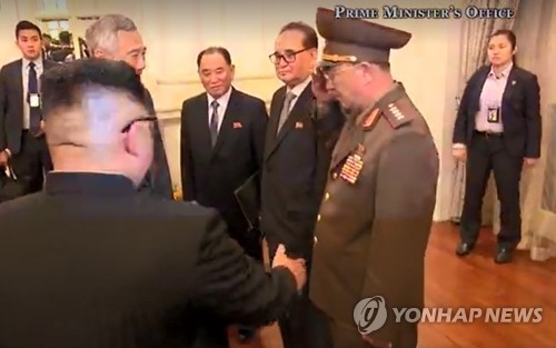 This image from the Singaporean Prime Minister's Office shows North Korean Minister of the People's Armed Forces No Kwang-chol (R) attending a meeting between the North's leader Kim Jong-un and Singaporean Prime Minister Lee Hsien Loong on June 10, 2018. (Yonhap)