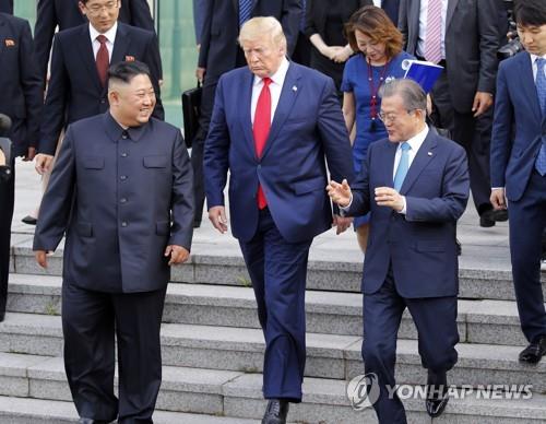 North Korean leader Kim Jong-un (L) walks with U.S. President Donald Trump (C) and South Korean President Moon Jae-in toward the northern side of the truce village of Panmunjom in the Demilitarized Zone, which separates the two Koreas, on June 30, 2019, after holding talks with Trump at the Freedom House on the village's southern side. (Yonhap)