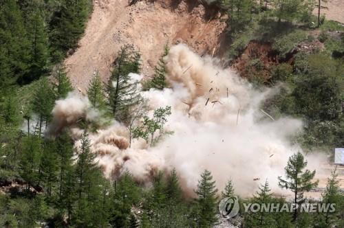 The North Portal, also known as Tunnel No. 2, of North Korea's only known nuclear test site, Punggye-ri, is blown up on May 24, 2018, in this press pool photo. South Korean journalists covering the process said the demolition of the site was carried out in a series of explosions over several hours on the day. (Yonhap)