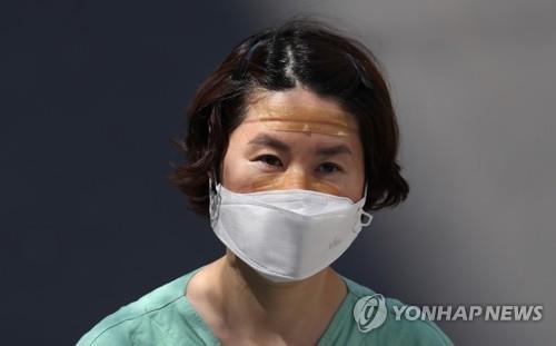 A medical worker looks tired after completing a shift for the service of people infected with the new coronavirus at a hospital in the southeastern city of Daegu, the epicenter of South Korea's COVID-19 virus outbreak, on April 3, 2020. (Yonhap)