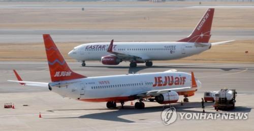 This file photo, taken Dec. 19, 2019, shows planes operated by Jeju Air and Eastar Jet at Gimpo International Airport in western Seoul. (Yonhap)