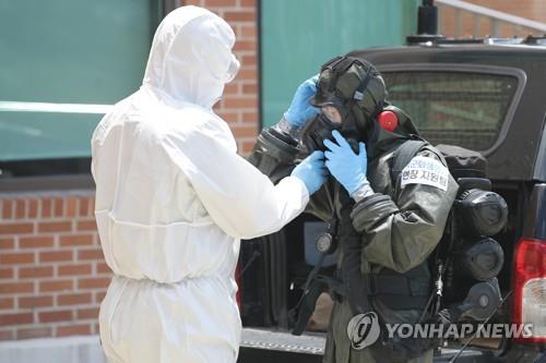 A team from the Armed Force CBR Defense Command wears protective gear to carry out disinfection work at a nursing home in cohort isolation in Gwangju, 329 kilometers south of Seoul, on July 17, 2020. (Yonhap)(END)