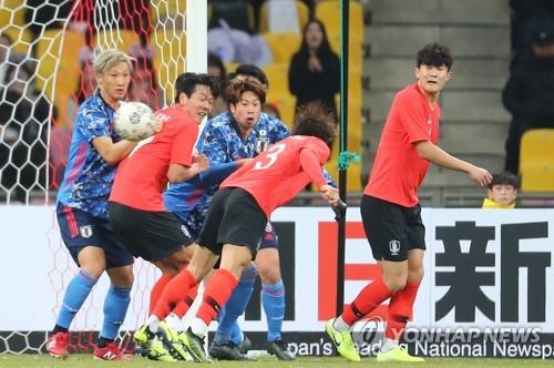 In this file photo from Dec. 18, 2019, South Korea (in red tops) and Japan are in action in the final of the East Asian Football Federation (EAFF) E-1 Football Championship at Busan Asiad Main Stadium in Busan, 450 kilometers southeast of Seoul. (Yonhap)