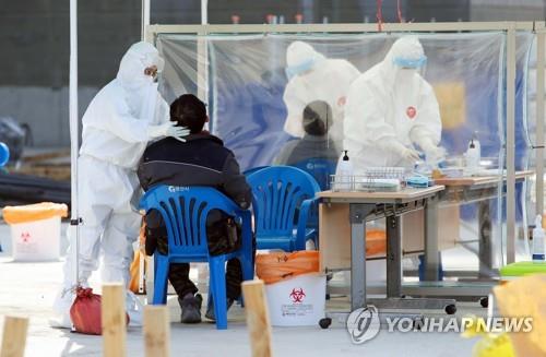 A man gets tested for COVID-19 in Gyeongsan, North Gyeongsang Province, on March 11, 2021. (Yonhap)