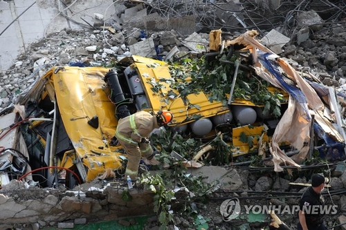 A firefighter checks the site of an accident in the southwestern city of Gwangju on June 9, 2021. (Yonhap) 