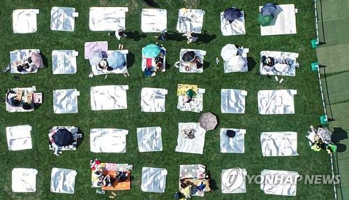 This bird's-eye view photo shows visitors listening to music at "Beautiful Mint Life 2021," an outdoor music festival held at Olympic Park in southeastern Seoul on June 27, 2021. (Yonhap)