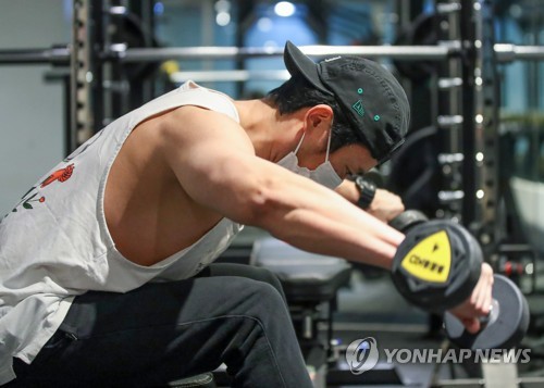 This undated file photo, used as a reference image, shows a man working out at a gym in Seoul. (Yonhap)