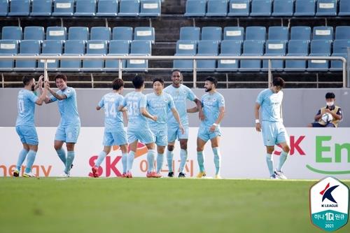 In this Sept. 22, 2021, file photo provided by the Korea Professional Football League, Daegu FC players celebrate a goal by Edgar (3rd from R) during their K League 1 match against Jeju United at Jeju World Cup Stadium in Seogwipo, Jeju Island. (PHOTO NOT FOR SALE) (Yonhap)