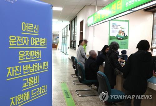 This file photo shows a signboard encouraging elderly drivers to voluntarily surrender their licenses at a community service center. (Yonhap) 