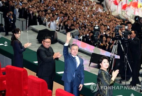In this file photo, taken Sept. 19, 2018, South Korean President Moon Jae-in raises his hand to acknowledge the welcoming crowd at a mass gymnastics and artistic performance at the May Day Stadium in Pyongyang. (Pool photo) (Yonhap) 