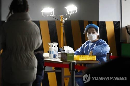 A health official checks the results of rapid antigen COVID-19 tests at a makeshift testing station in the southwestern city of Gwangju on Feb. 16, 2022, in this photo provided by the local government. (PHOTO NOT FOR SALE) (Yonhap) 