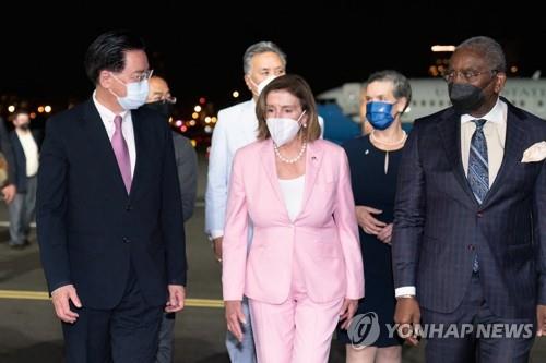 U.S. House Speaker Nancy Pelosi (C) arrives at Taipei Songshan Airport on Aug. 2, 2022, in this photo released by AFP. (Yonhap)