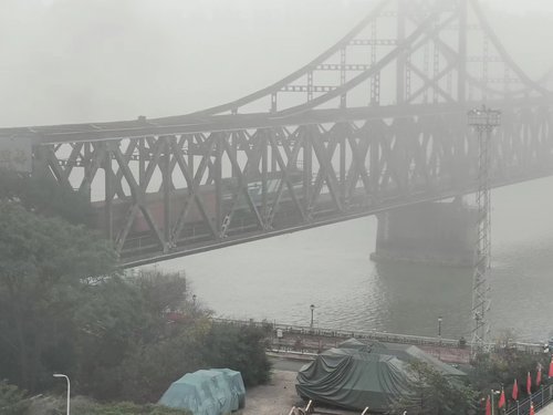 A cargo train crosses a railway bridge from the Chinese border city of Dandong toward North Korea's northern city of Sinuiju on Sept. 26, 2022. (Yonhap)