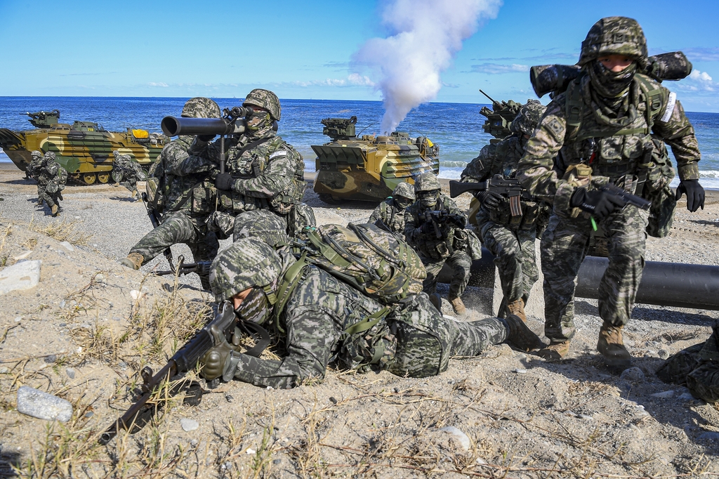 Troops secure a target area during the military's amphibious landing drills at a coastal area in Pohang, 272 kilometers southeast of Seoul, on Oct. 26, 2022, in this photo provided by the Marine Corps. (PHOTO NOT FOR SALE) (Yonhap)