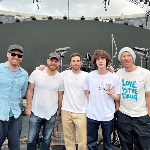 BTS' Jin (2nd from R) and British rock band Coldplay pose for the camera during a rehearsal for their joint performance of "The Astronaut" at Coldplay's concert in Buenos Aires, Argentina, on Oct. 28, 2022. This photo was captured from the British band's Twitter account. (PHOTO NOT FOR SALE) (Yonhap)