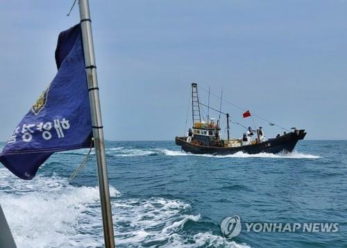 This file photo, provided by the Korea Coast Guard on Sept. 13, 2022, shows its crackdown on a Chinese fishing boat for illegal fishing near a South Korean island in the Yellow Sea. (PHOTO NOT FOR SALE) (Yonhap)