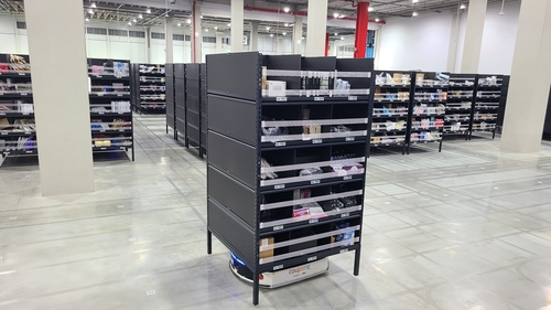 An Automated Guidance Vehicle moves a shelf stocked with inventory at Coupang Inc.'s fulfillment center in Daegu, 237 kilometers south of Seoul, on Feb. 3, 2023. (Yonhap)