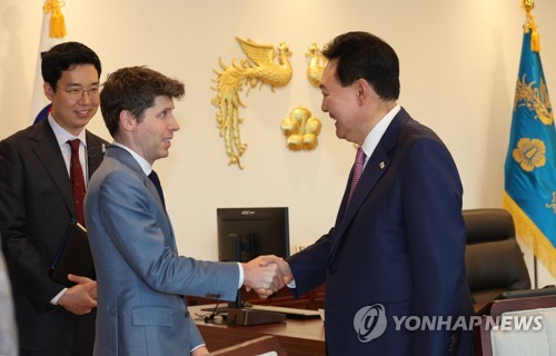 South Korean President Yoon Suk Yeol (R) shakes hands with Sam Altman, CEO of OpenAI, the creator of ChatGPT, at his office in Yongsan, central Seoul, on June 9, 2023. (Yonhap)
