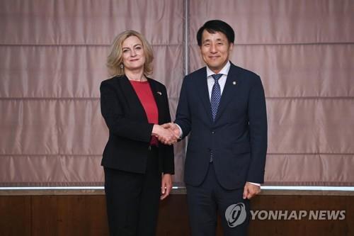 In this photo provided by South Korea's industry ministry, First Vice Industry Minister Jang Young-jin (R) shakes hands with Latvia's economic minister, Ilze Indriksone, ahead of their talks in Seoul on July 14, 2023. (PHOTO NOT FOR SALE) (Yonhap)
