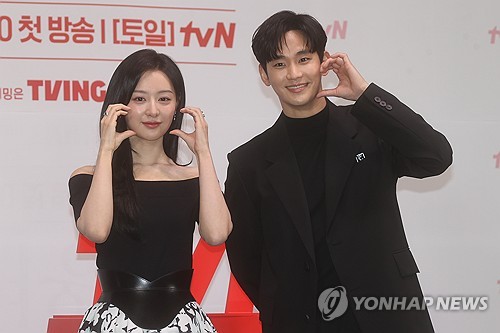Kim Ji-won (L) and Kim Soo-hyun pose for photos during a press event for tvN's upcoming drama "Queen of Tears" in Seoul on March 7, 2024. (Yonhap)