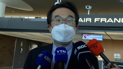 米国を離れる前、ダレス国際空港で特派員の問いかけに応じる李本部長＝３０日、ワシントン（聯合ニュース）