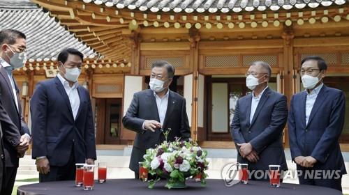 青瓦台で４大企業グループの代表と歓談する文大統領（中央）＝２日、ソウル（聯合ニュース）